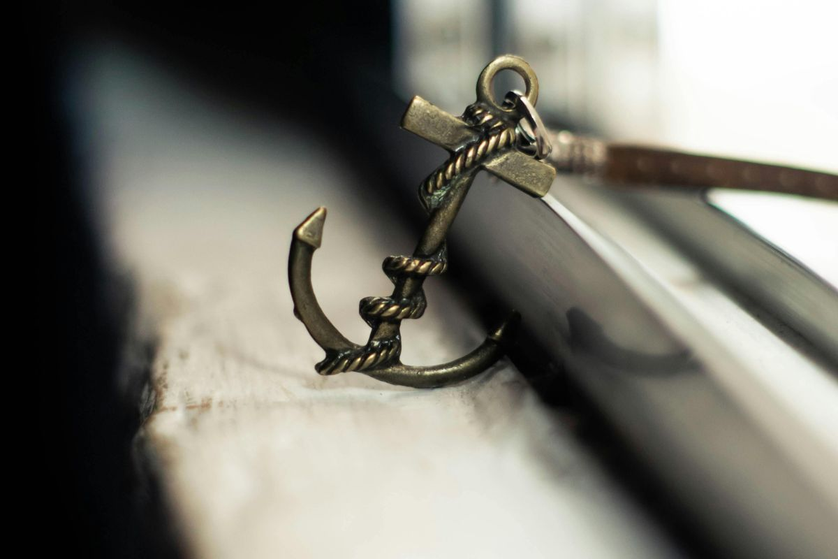 small anchor charm sitting on a windowsill
