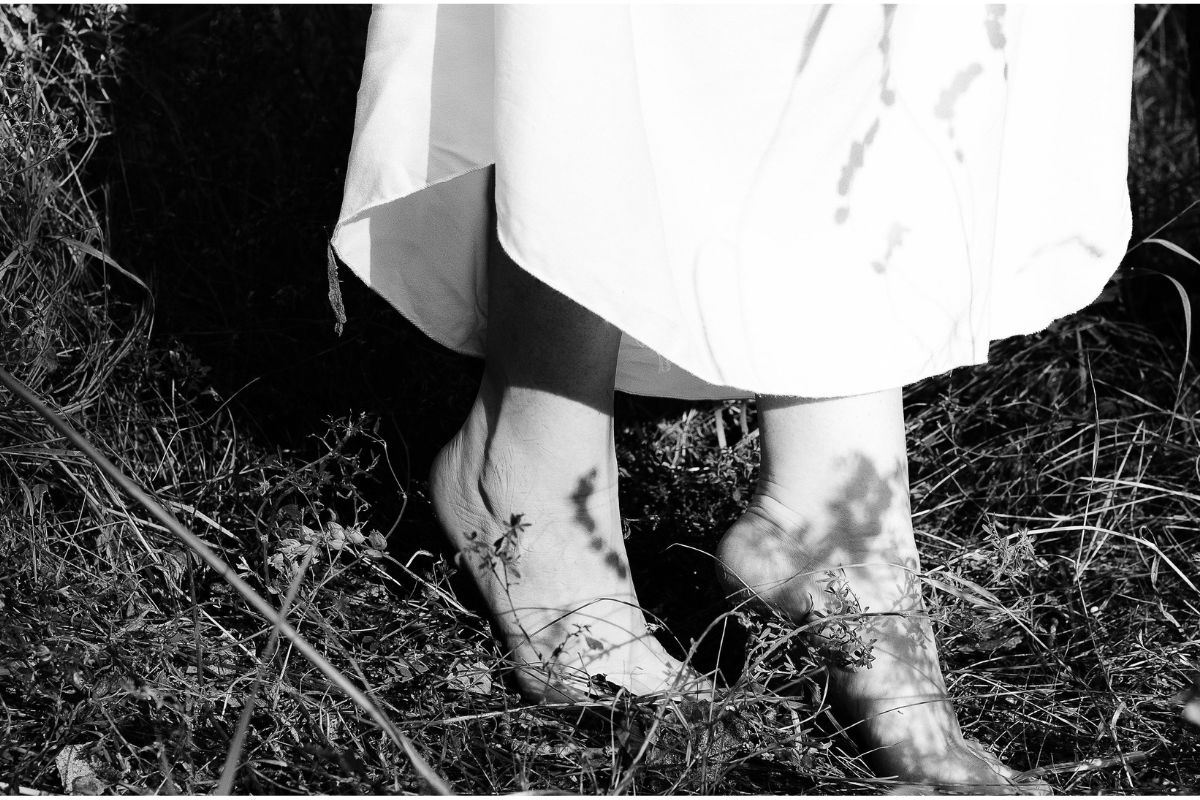 a woman's bare feet in a field of grass