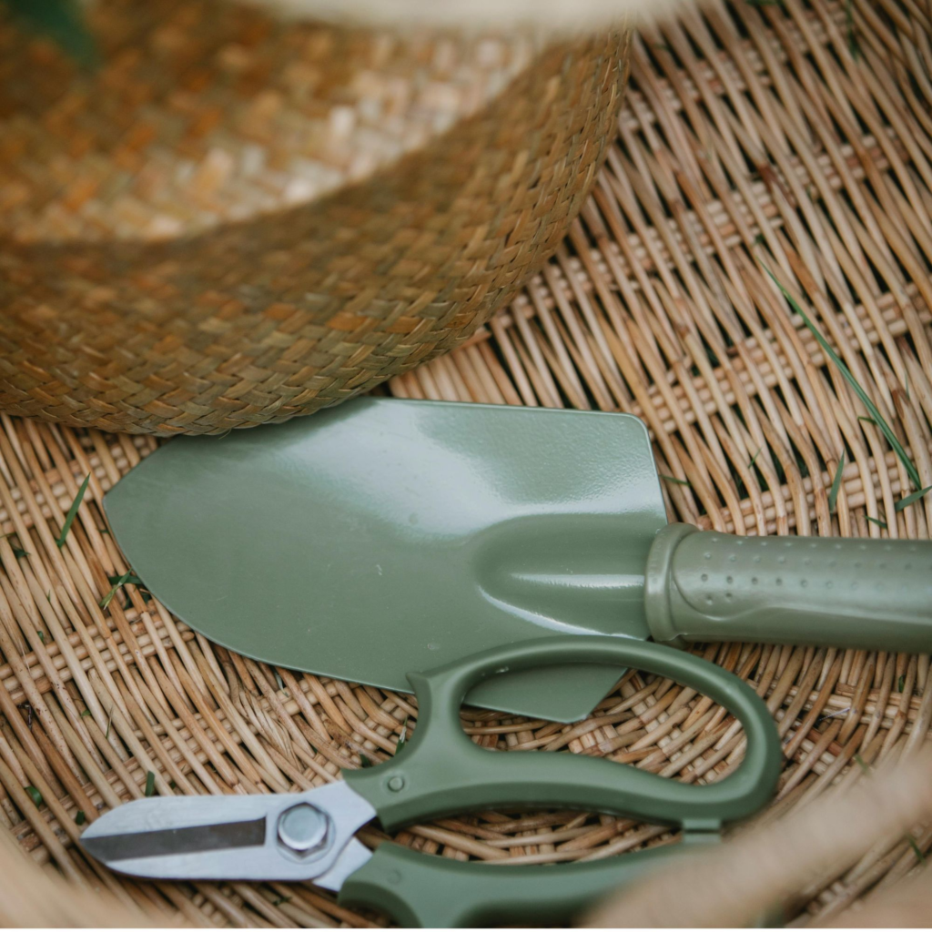 Gardening tools in a brown wicker basket