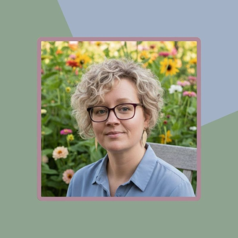 close up shot of author in a garden of cut flowers on a geometrical sage and light blue background